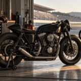 サーキットのピットで整備用スタンドに載せられた黒いバイク